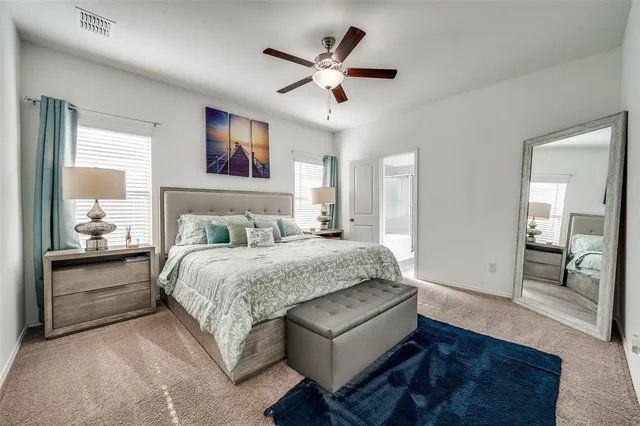 a bedroom with a large bed and a chandelier