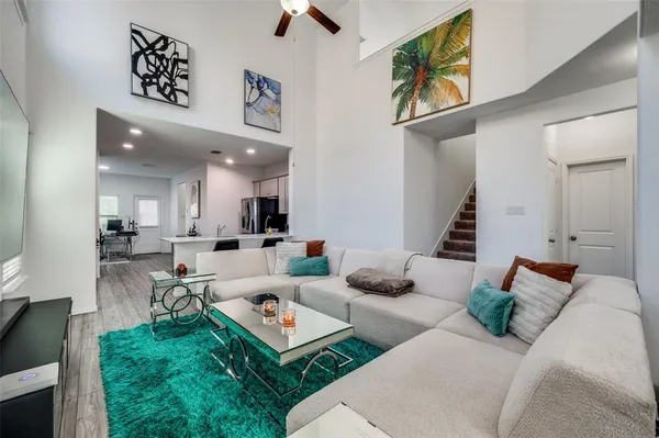 a living room with furniture and a large mirror