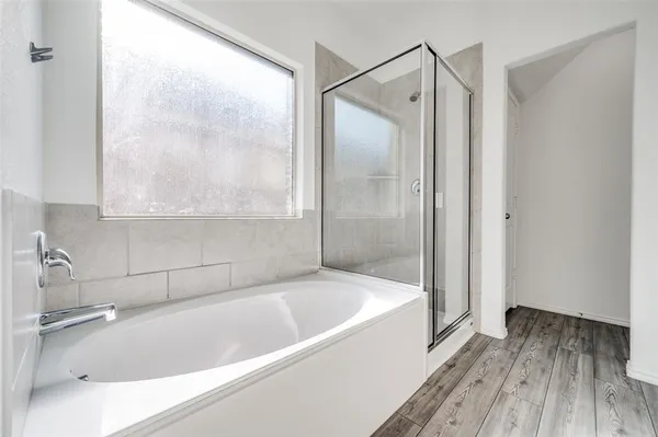 a bathroom with a bathtub and a shower