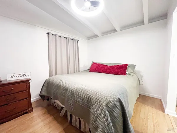 a bedroom with a bed and a dresser