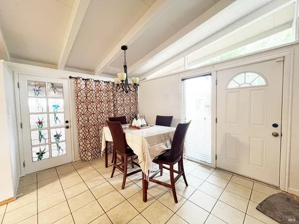 a view of a dining room with furniture and chandelier