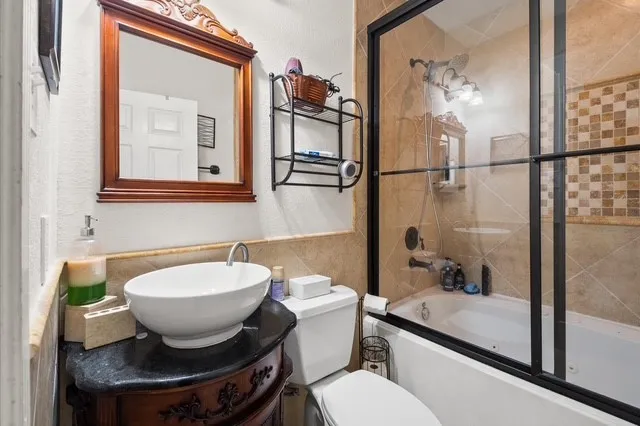 a bathroom with a toilet a sink and mirror