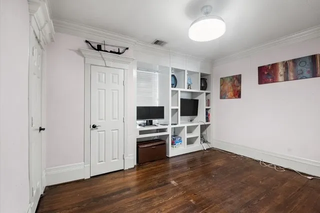 a view of a kitchen with a sink stove cabinets and empty room