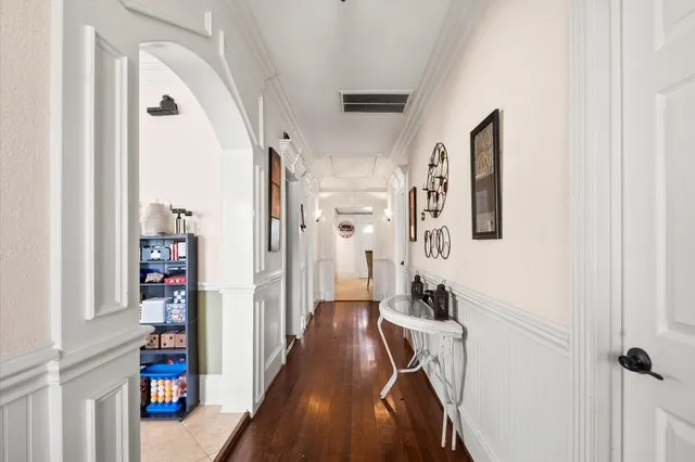 a view of a hallway with wooden floor and entryway