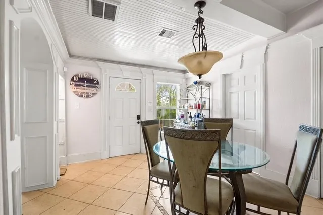 a view of a dining room with furniture and chandelier