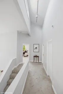 a view of a bedroom with furniture and window