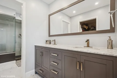 a bathroom with a granite countertop sink mirror and double