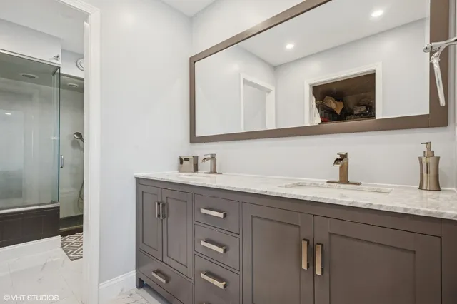 a bathroom with a granite countertop sink mirror and double