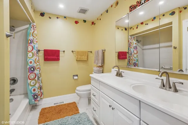 a bathroom with a sink vanity granite and toilet