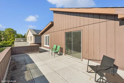 a backyard of a house with table and chairs
