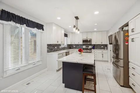 a kitchen with stainless steel appliances granite countertop a refrigerator sink and cabinets
