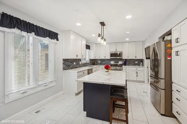 a kitchen with stainless steel appliances granite countertop a refrigerator sink and cabinets