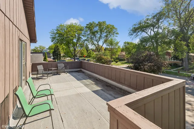 a view of roof deck with furniture and trees