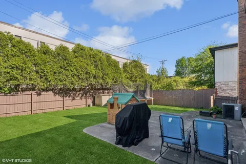 a view of yard with green space and seating