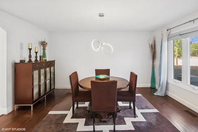 a view of a dining room with furniture window and wooden floor