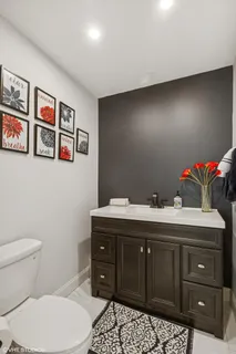 a bathroom with a sink vanity and toilet
