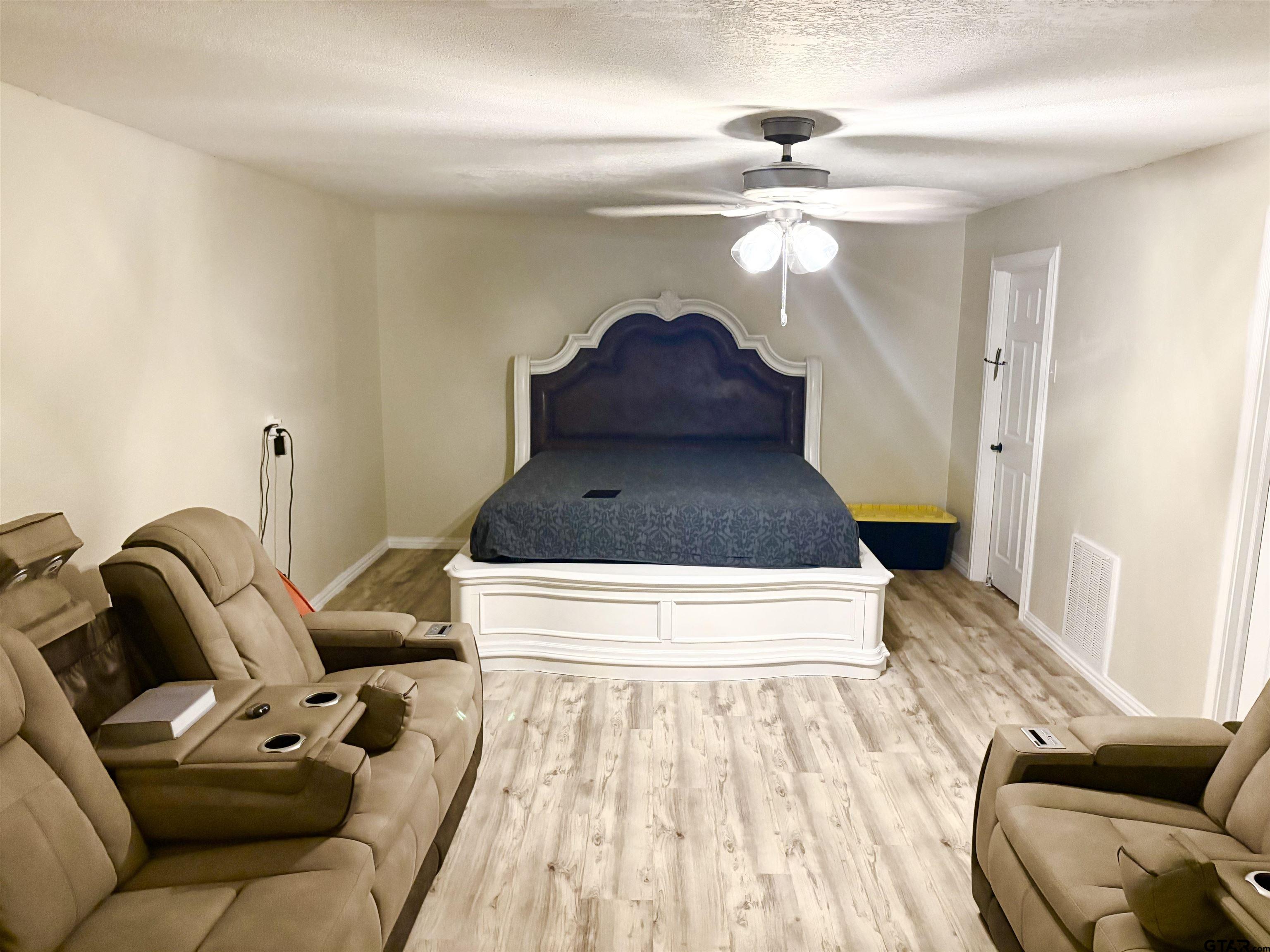 705 North Edwards Avenue Mount Pleasant, TX 75455 - Photo 32 of 36 a living room with furniture and a chandelier