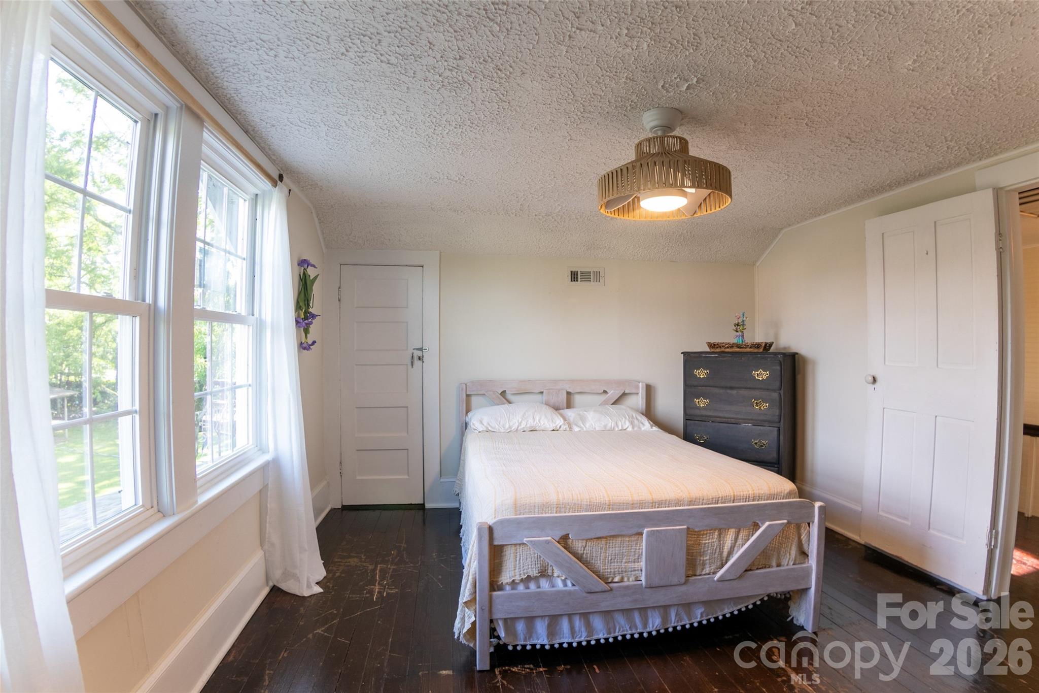 102 Cuthberson Street Morganton, NC 28655 - Photo 31 of 45 a bedroom with a bed and a chandelier