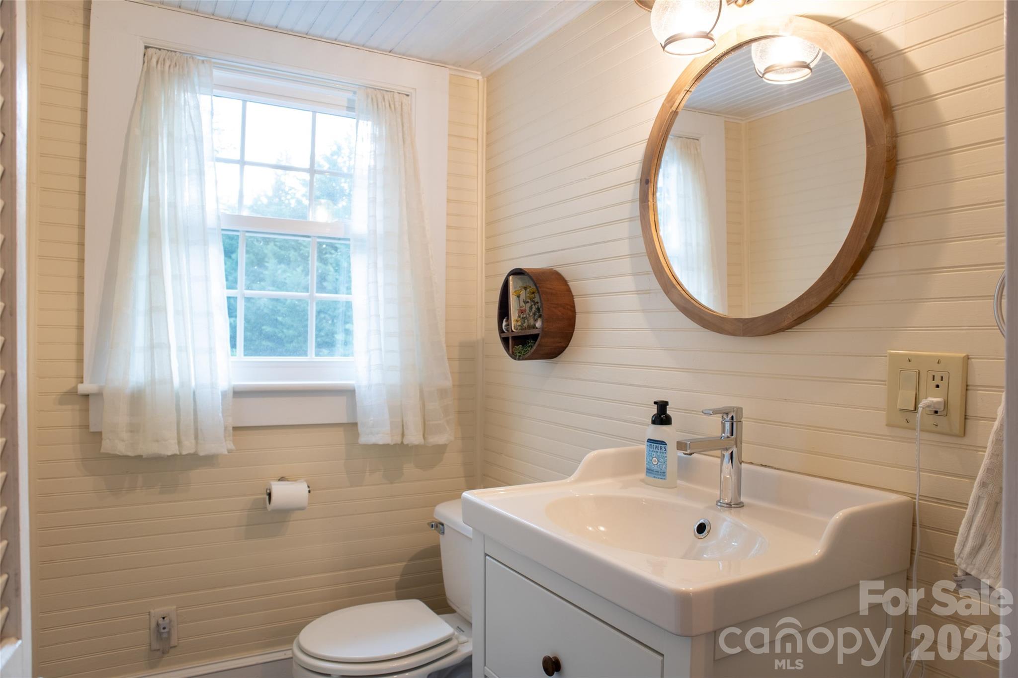 102 Cuthberson Street Morganton, NC 28655 - Photo 32 of 45 a bathroom with a toilet sink and mirror