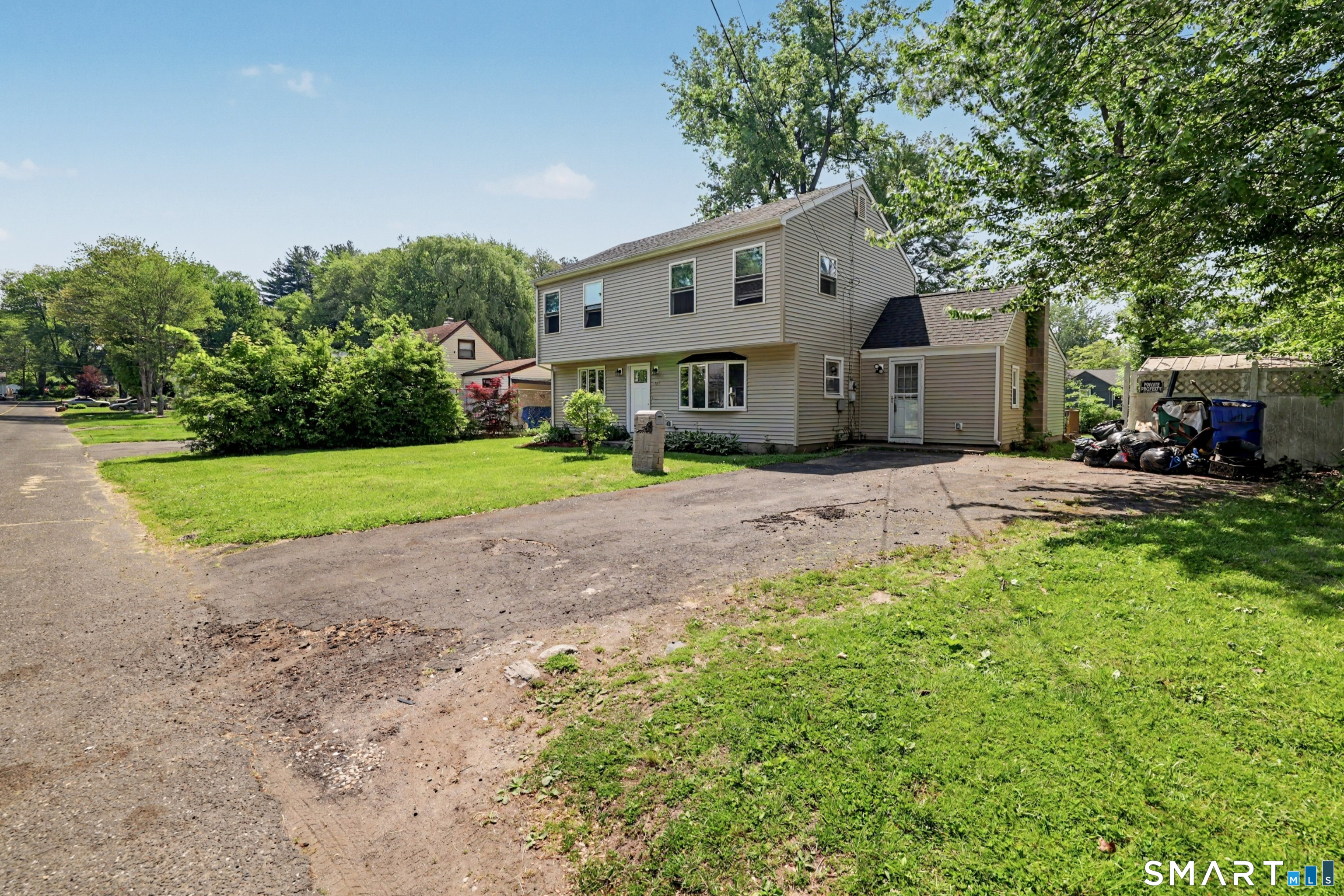 97 Boothbay Street Bloomfield, CT 06002 - Photo 4 of 33 a front view of a house with a yard and trees