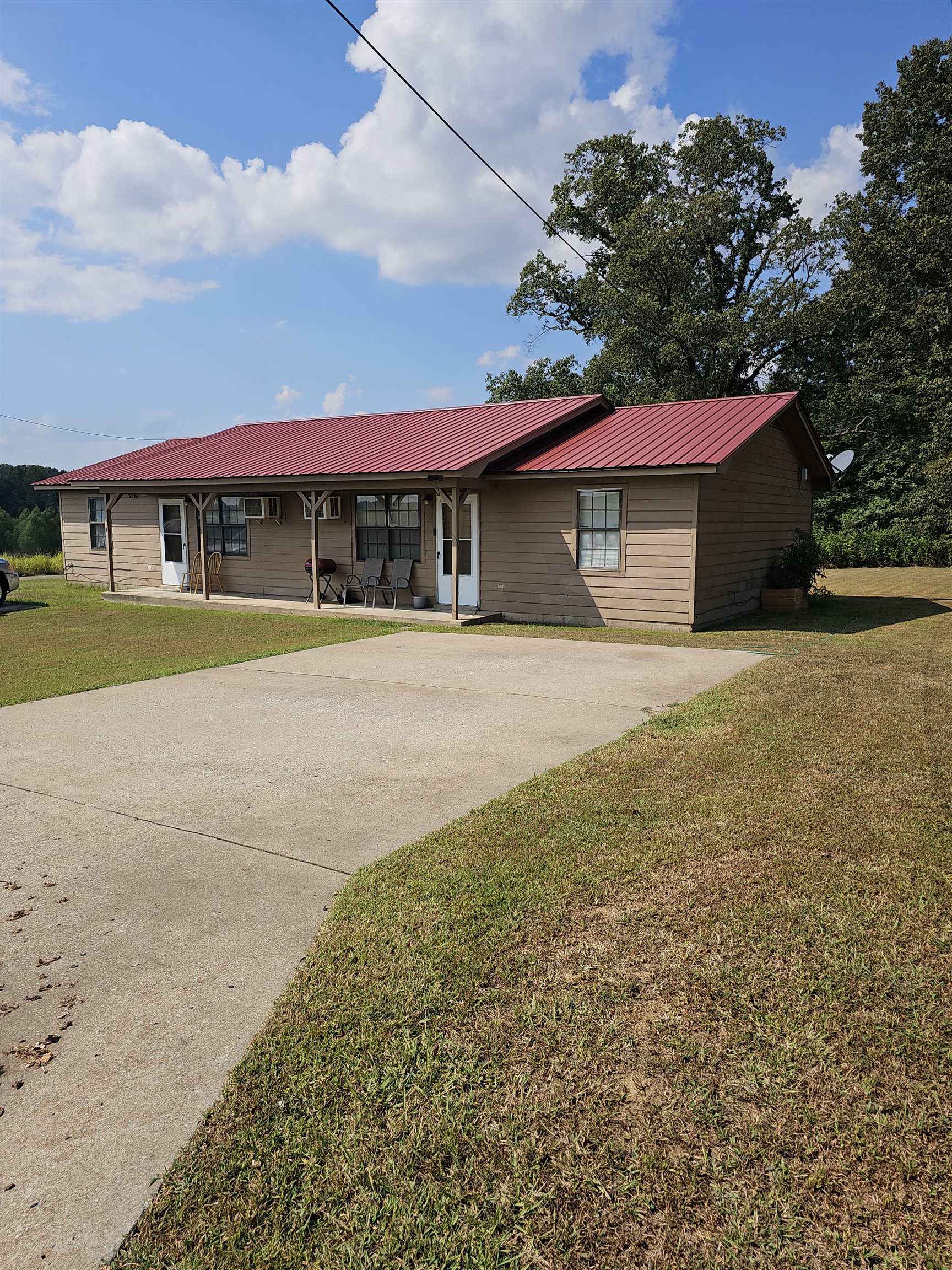 74 Oakhill Subdivision Road Ripley, TN 38063 - Photo 3 of 8 a front view of a house with a yard and garage