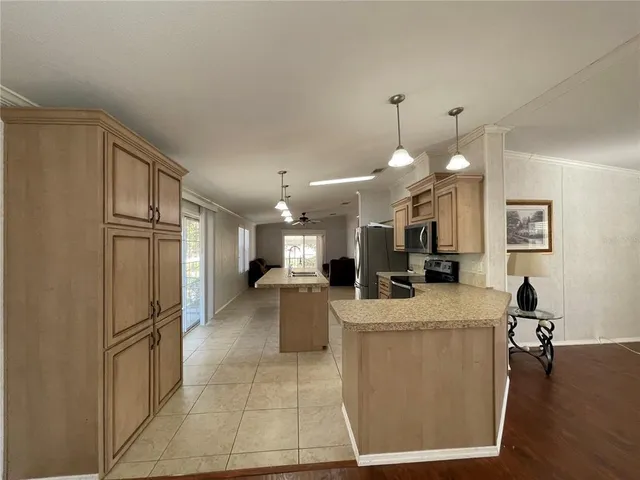 a view of a livingroom with a ceiling fan and window