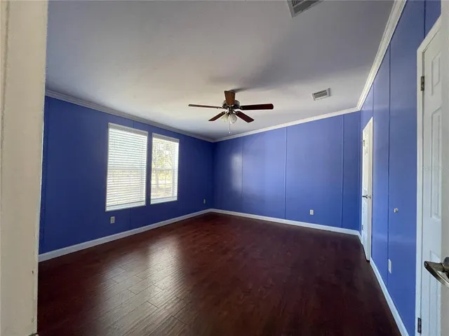 a view of empty room with refrigerator