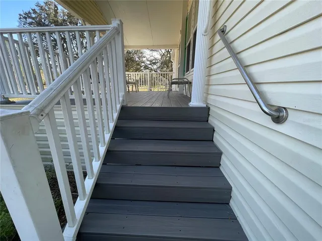 a view of a kitchen with furniture and stainless steel appliances