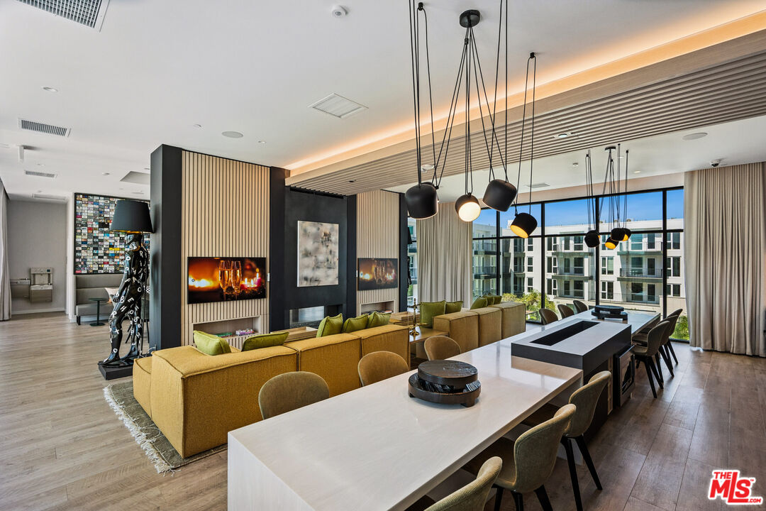 2455 Overland Avenue, Unit 564 Los Angeles, CA 90064 - Photo 16 of 23 a living room with furniture and a flat screen tv