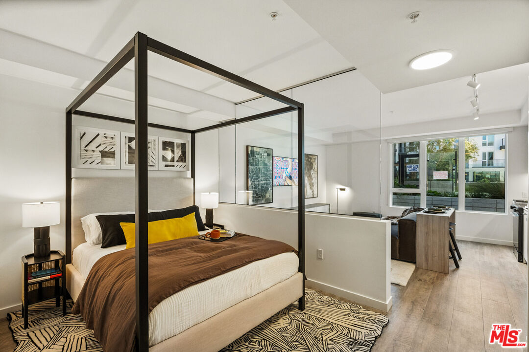 2455 Overland Avenue, Unit 564 Los Angeles, CA 90064 - Photo 21 of 23 a bed room with a bed and wooden floor