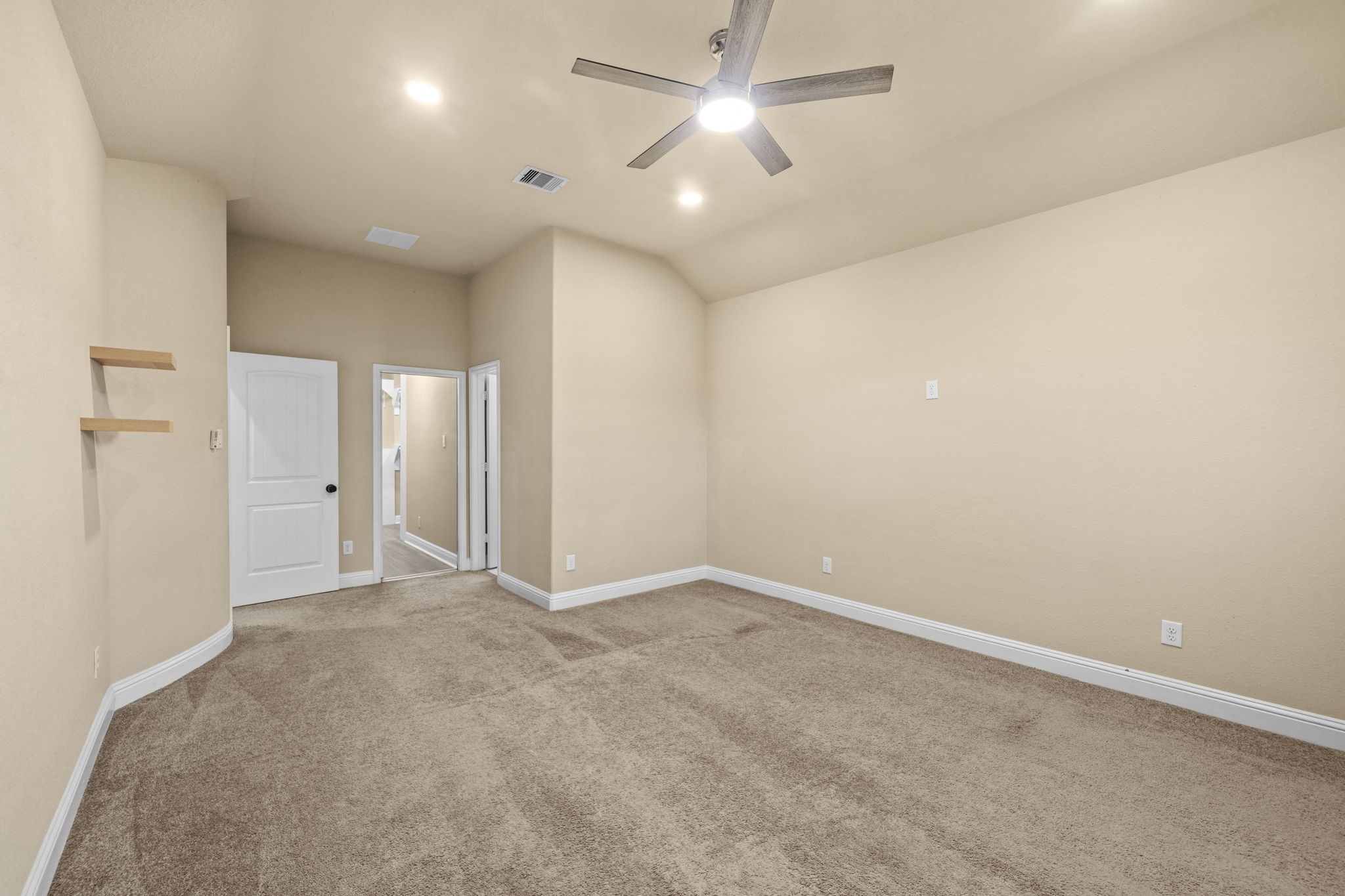 14215 Spindle Arbor Road Cypress, TX 77429 - Photo 22 of 47 This room features carpeted flooring, beige walls, recessed lighting, and a ceiling fan. It includes a white door and a closet with mirrored sliding doors, adding functionality and brightness.