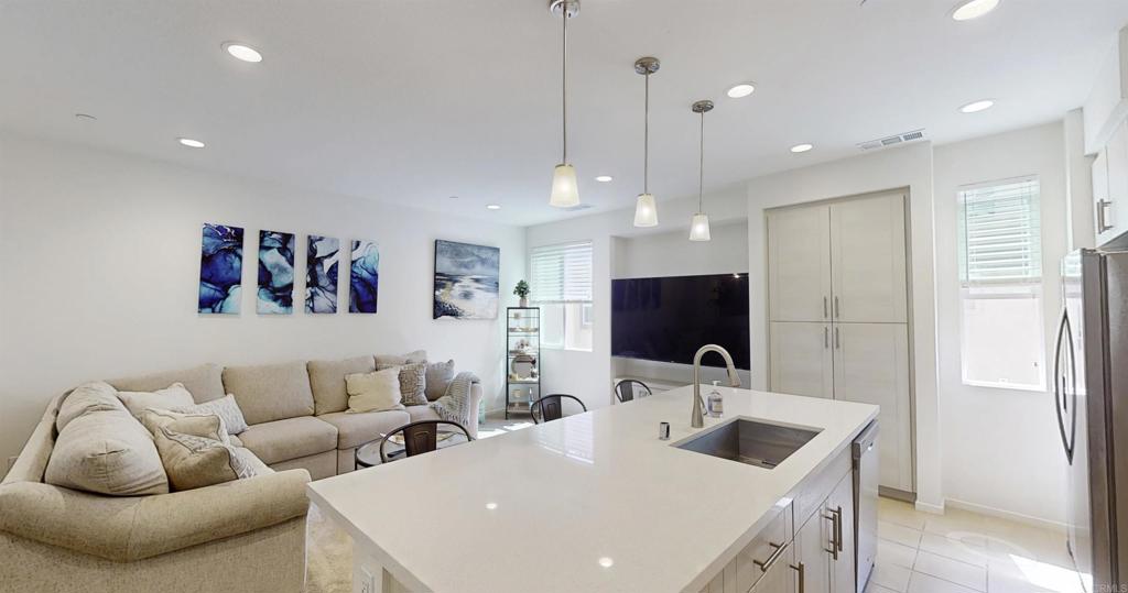 1150 Via Lucero Oceanside, CA 92056 - Photo 1 of 11 a living room with furniture kitchen view and a sink