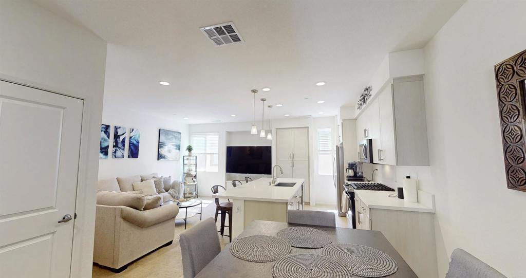 1150 Via Lucero Oceanside, CA 92056 - Photo 5 of 11 a living room with furniture and a flat screen tv