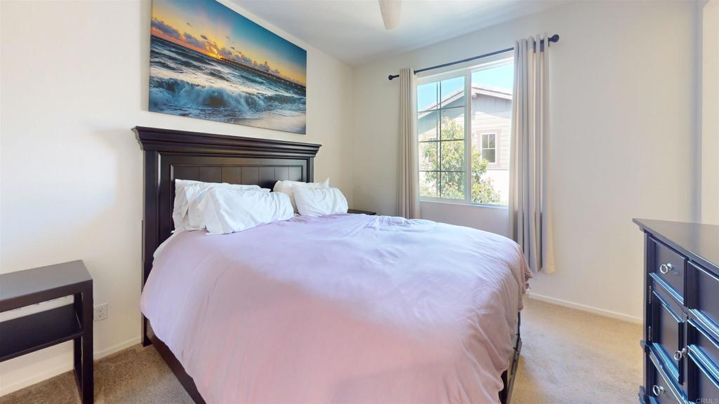 1150 Via Lucero Oceanside, CA 92056 - Photo 6 of 11 a bedroom with a bed and wooden floor