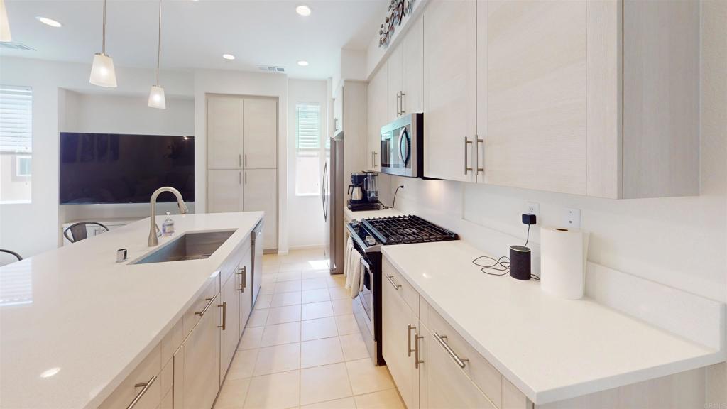 1150 Via Lucero Oceanside, CA 92056 - Photo 8 of 11 a kitchen that has a sink and a stove in it