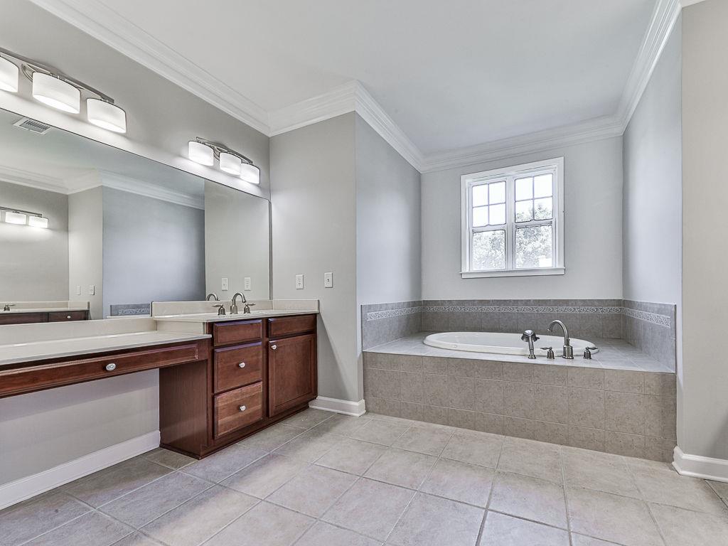 626 Laurel Crossing Canton, GA 30114 - Photo 33 of 77 a large spacious bathroom with a large tub sink and mirror