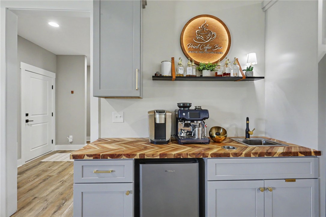701 Coneross Creek Road Seneca, SC 29678 - Photo 10 of 35 A custom coffee bar with chevron wood countertops and coordinating cabinetry adds both style and convenient extra storage.