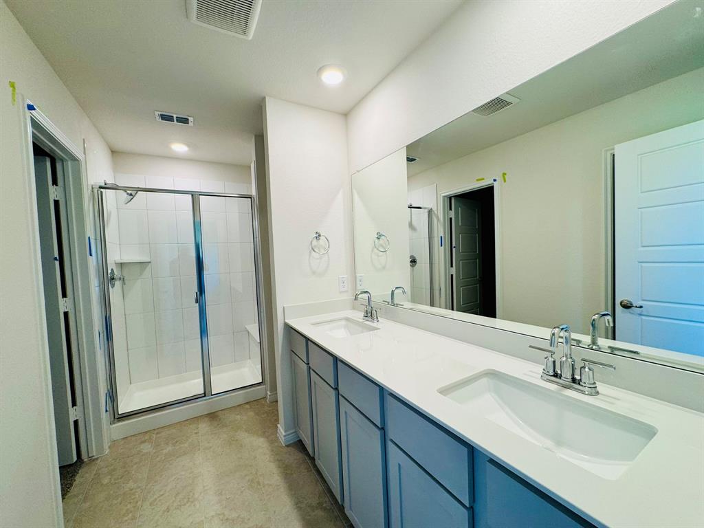 4028 Moss Road Pilot Point, TX 76258 - Photo 11 of 29 a bathroom with a double vanity sink mirror and shower
