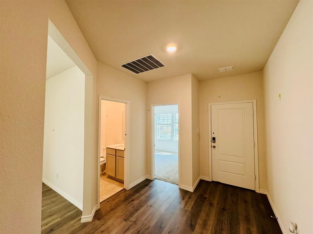 4028 Moss Road Pilot Point, TX 76258 - Photo 2 of 29 a view of an empty room with wooden floor and a window