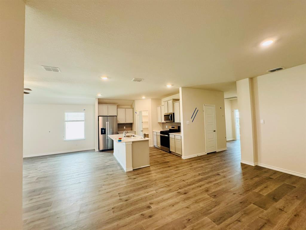 4028 Moss Road Pilot Point, TX 76258 - Photo 27 of 29 a view of kitchen and dining room with wooden floor