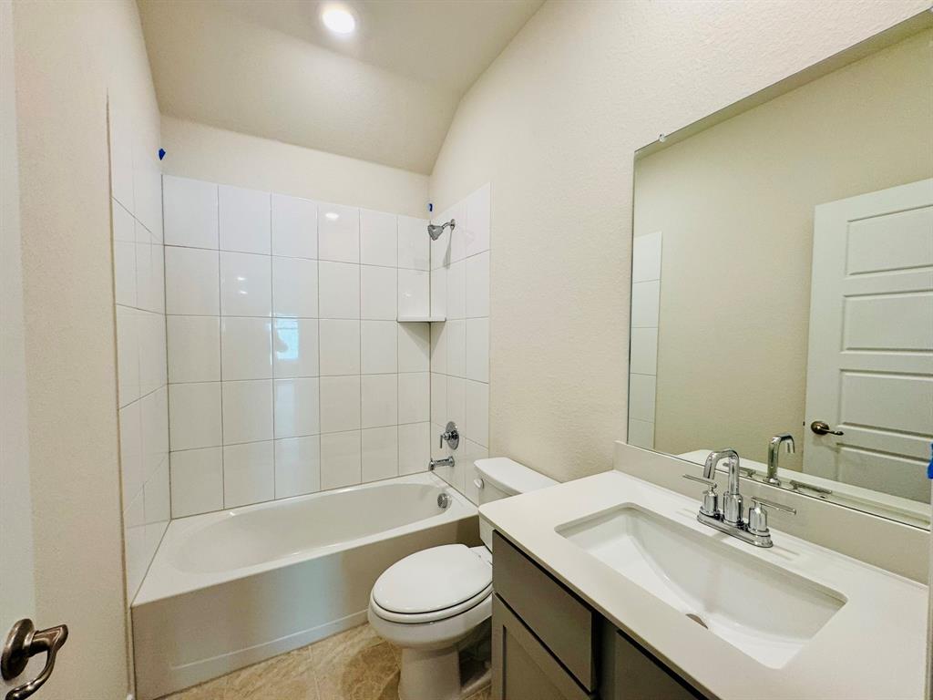 4028 Moss Road Pilot Point, TX 76258 - Photo 7 of 29 a bathroom with a sink a toilet and shower