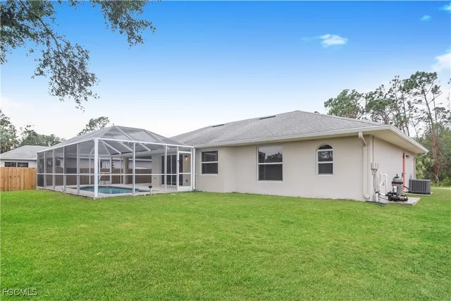 a view of a house with a yard and sitting area