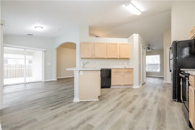 a kitchen with wooden floors and white appliances