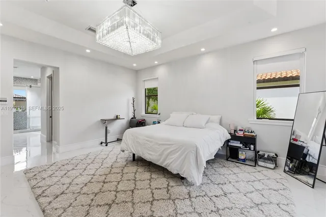 a bedroom with a bed a mirror and furniture