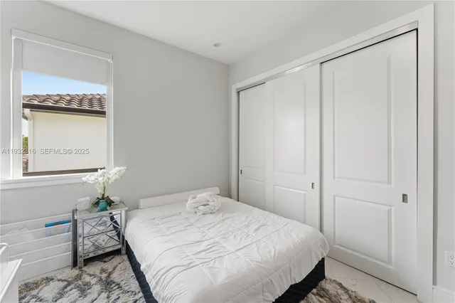 a bedroom with a bed and a table