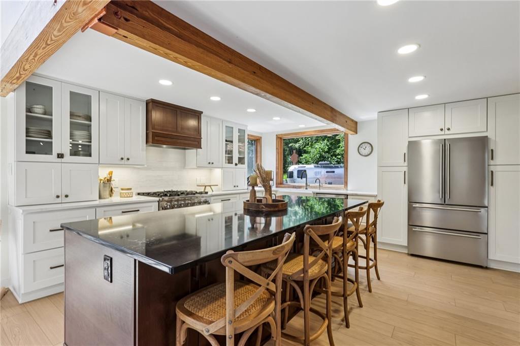 8110 Ridge Road Natrona Heights, PA 15065 - Photo 14 of 50 a kitchen with a table chairs refrigerator and microwave