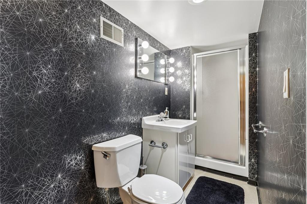 8110 Ridge Road Natrona Heights, PA 15065 - Photo 34 of 50 a white toilet sitting next to a bathroom sink