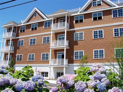89 Lewis Bay Road, Unit 202 Hyannis, MA 02601 - Photo 4 of 5 a front view of a house with a yard