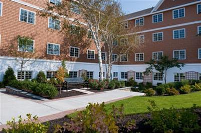 89 Lewis Bay Road, Unit 202 Hyannis, MA 02601 - Photo 5 of 5 a front view of a house with a yard and outdoor seating