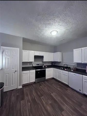 a kitchen with stainless steel appliances and wooden cabinets